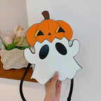 Front view of the white ghost-shaped bag with an orange pumpkin hat held in one hand.