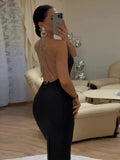 Rear view of a black fitted dress with cascading rhinestone chains over the open back