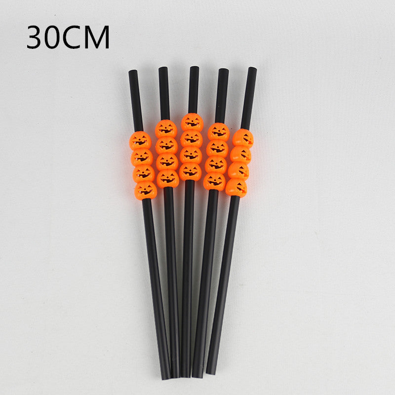 Five straight black Halloween straws, each decorated with a vertical row of orange jack-o'-lantern faces.