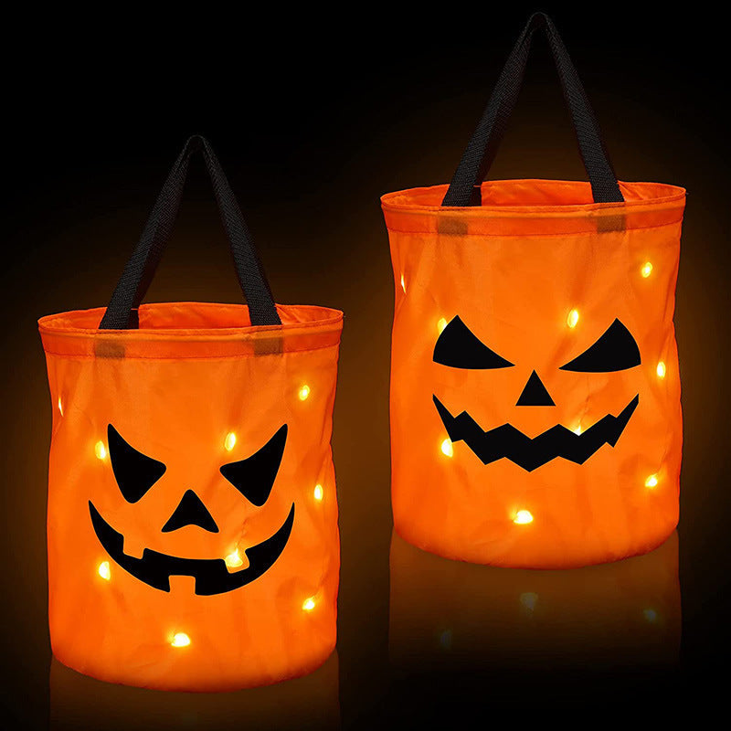 Two orange jack-o'-lantern candy bags shown with glowing points against a dark background.