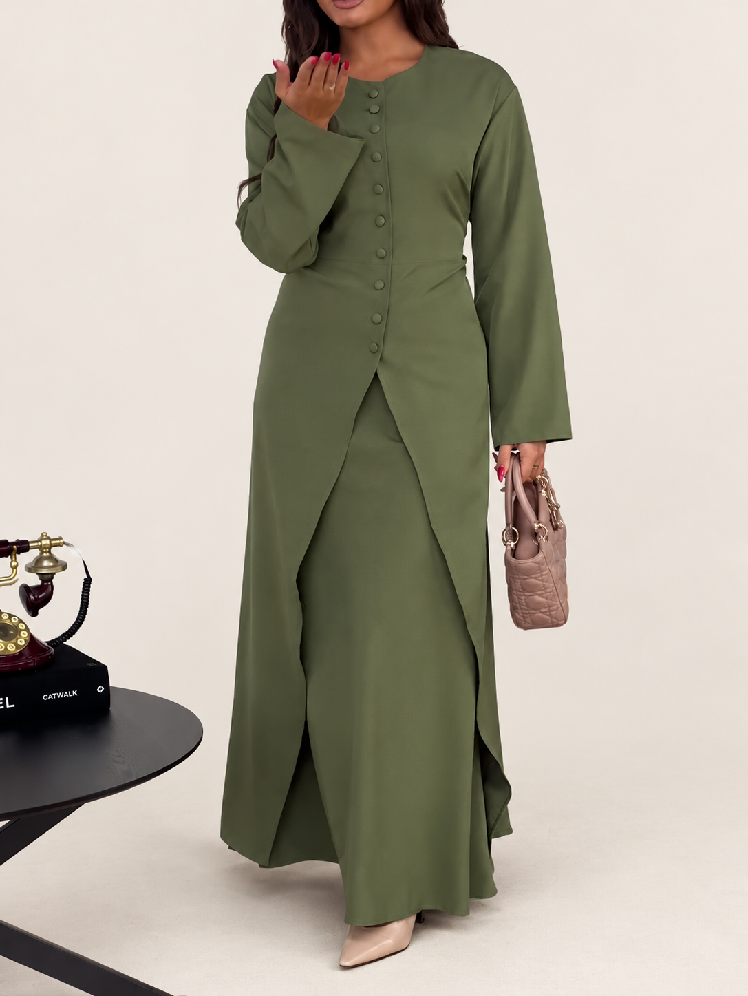 Model wearing an olive long button-front top and matching maxi skirt against a warm ivory studio background