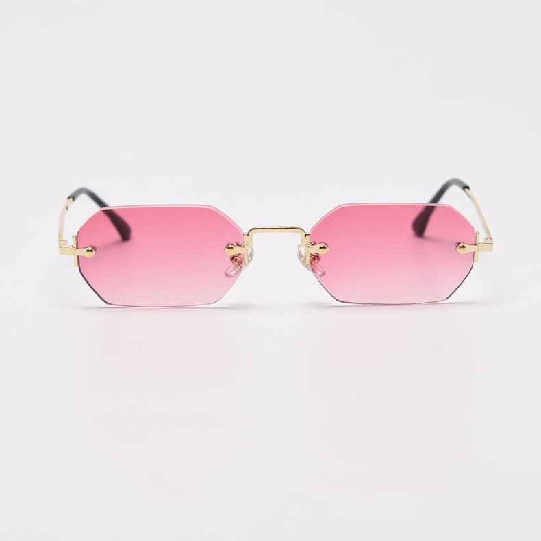 Polygonal rimless sunglasses with pink gradient lenses and a gold-tone bridge