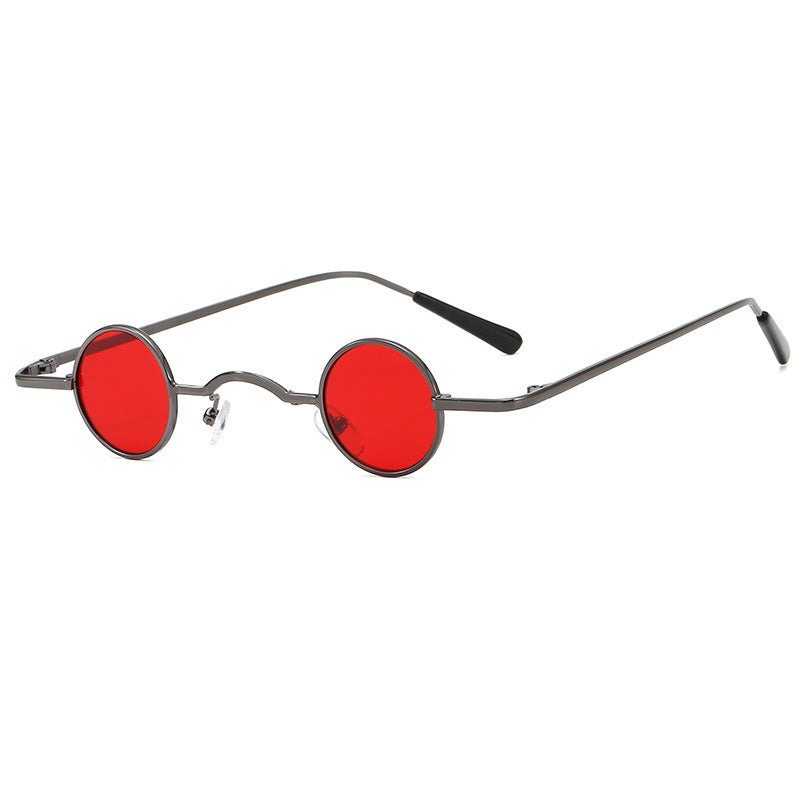 Small round red-lens sunglasses with dark metal frames on a white background