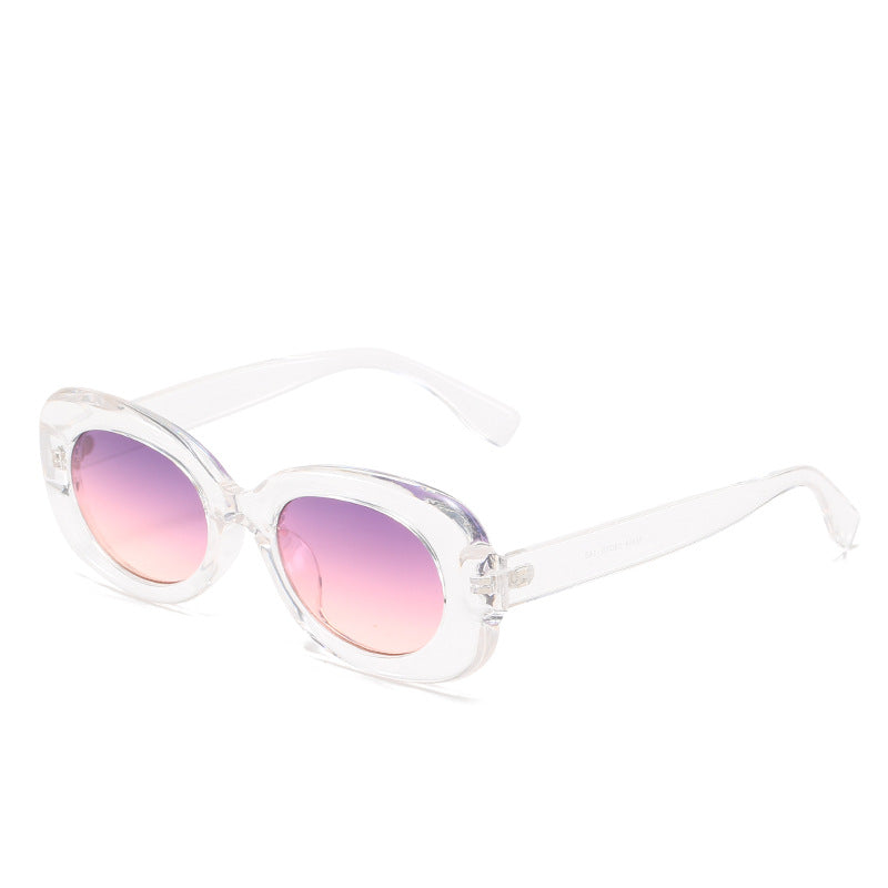 Transparent oval sunglasses with pink-gradient lenses on white.
