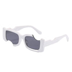 One pair of white angular-frame sunglasses with dark grey lenses on white