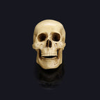 Cream-coloured skull decoration with dark eye sockets and an open jaw, shown front-on against a dark reflective background.