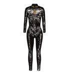 Black long-sleeve jumpsuit with a silver skeleton, star-like details and gold heart motif printed on the front, shown on a white background.