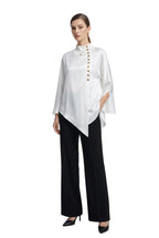Stand-collar shirt with asymmetric button placket, styled with black trousers.