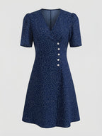 Blue V-neck dress with small white dots, short sleeves and front buttons — full product view