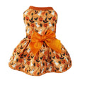 Orange Halloween pet dress with printed motifs and a large orange bow.