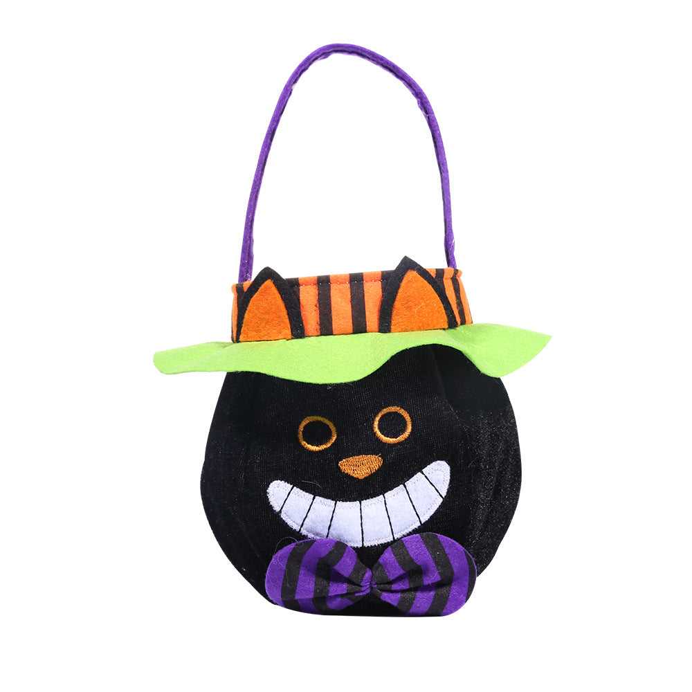 Black cat-face Halloween tote bag with a purple handle and bow, orange striped trim and a green hat brim, shown on white.
