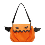 Orange pumpkin-face bag with black bat wings and a black handle