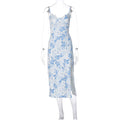 White dress with blue floral print, lace-trim neckline, thin straps and a side slit, shown on a transparent mannequin.