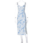 White dress with blue floral print, lace-trim neckline, thin straps and a side slit, shown on a transparent mannequin.