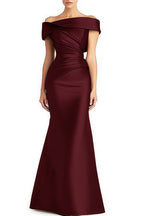 Wine-red off-shoulder floor-length gown with a folded neckline and asymmetric pleats across the bodice and waist