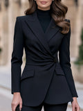 Black long-sleeve blazer with twist waist detail, front view.