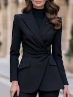 Black long-sleeve blazer with twist waist detail, front view.