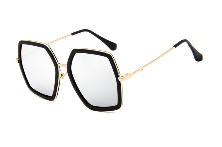 Oversized geometric glasses with a black frame, clear lenses and gold-tone arms on a white background