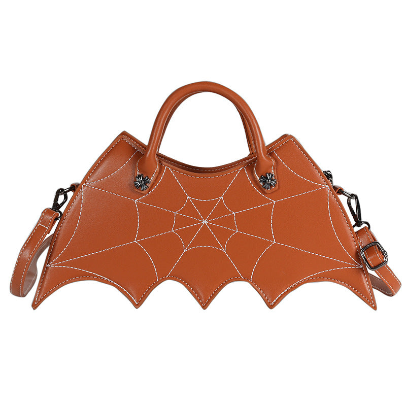 Brown bat-wing-shaped crossbody bag with spider-web stitching, handles and strap on white.