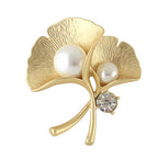 Gold-tone ginkgo leaf brooch with two pearl-look accents