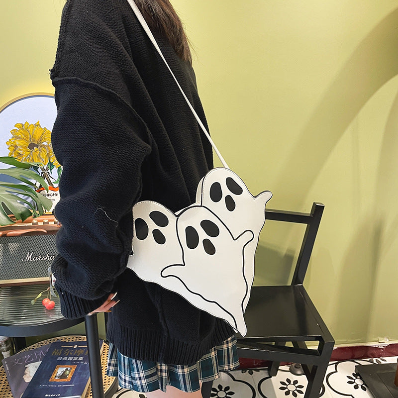 White Ghost Crossbody Bag worn at the hip with its shoulder strap.