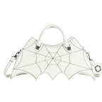 White bat-wing-shaped crossbody bag with spider-web stitching, handles and strap on white.