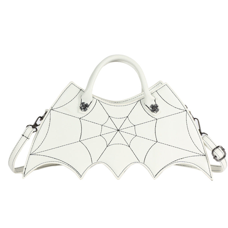 White bat-wing-shaped crossbody bag with spider-web stitching, handles and strap on white.