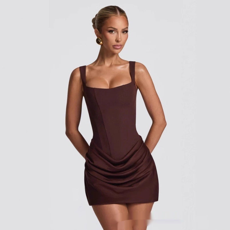 Model wearing a dark brown sleeveless fitted mini dress with a draped skirt