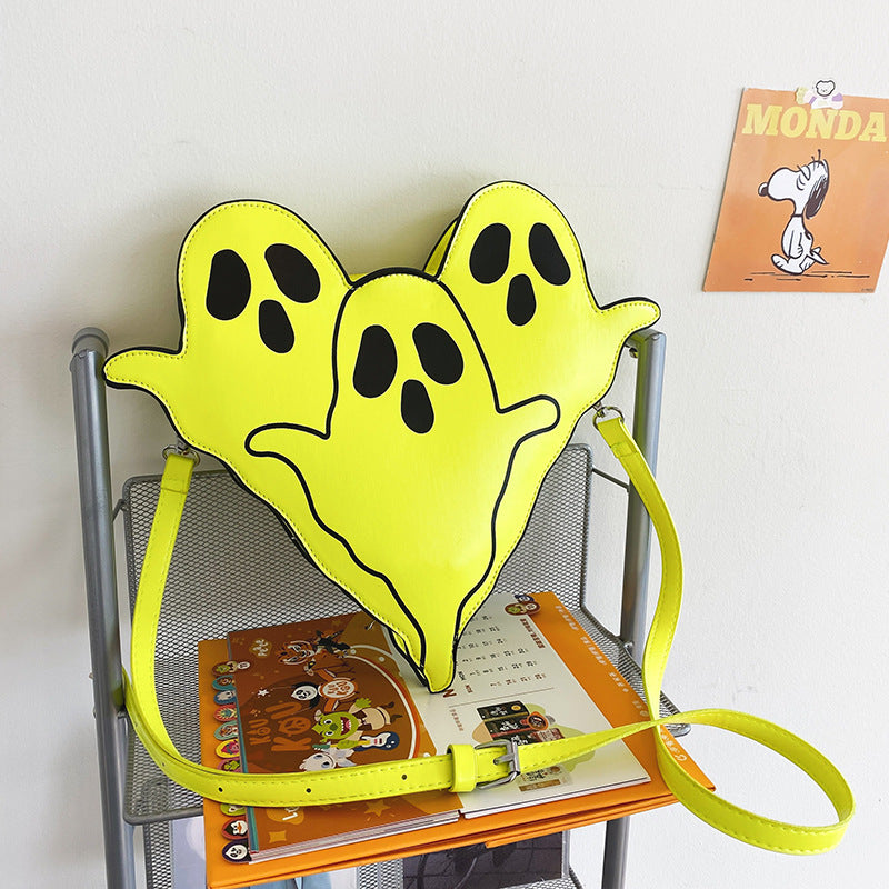 Bright green Ghost Crossbody Bag displayed on a chair with its shoulder strap.
