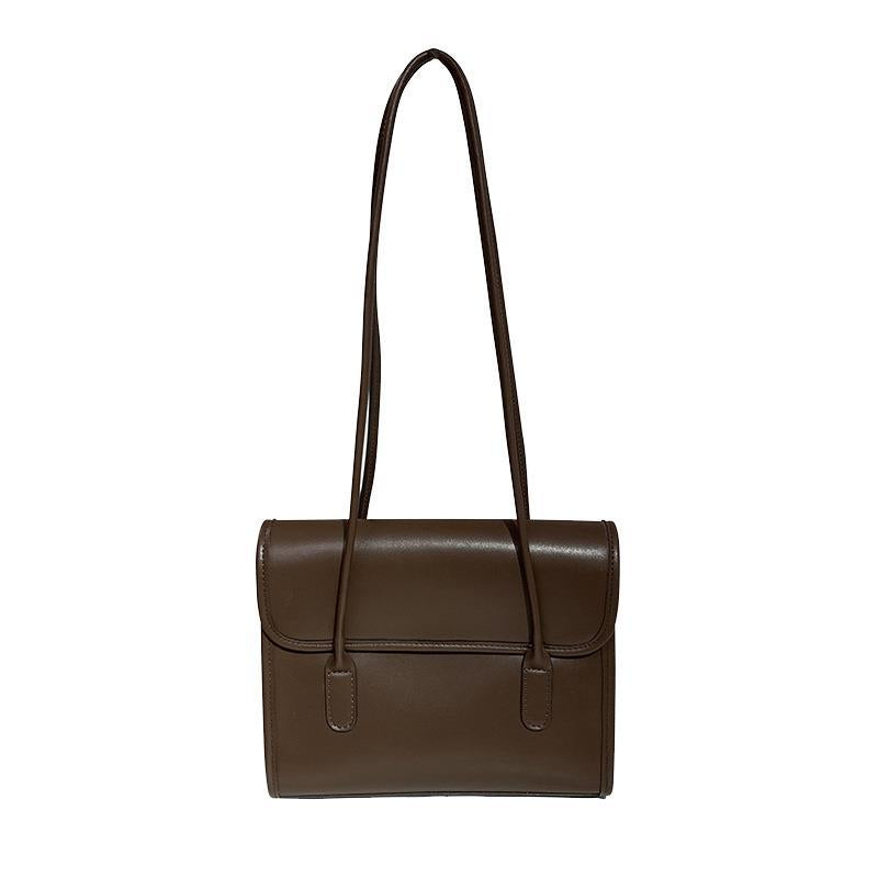 Brown rectangular shoulder bag with a rounded flap and two long narrow shoulder straps.