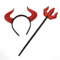 Red glitter devil-horn headband and matching trident prop with a black band and handle, shown together on white.
