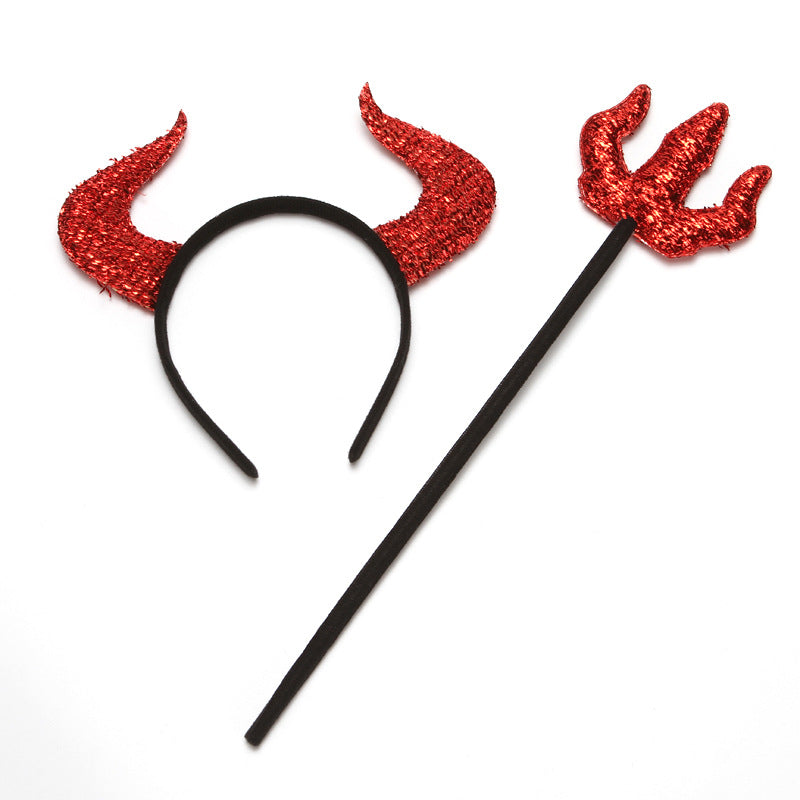 Red glitter devil-horn headband and matching trident prop with a black band and handle, shown together on white.