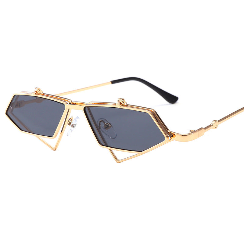 Angular gold-tone sunglasses with dark grey lenses and geometric lower frame detail on white