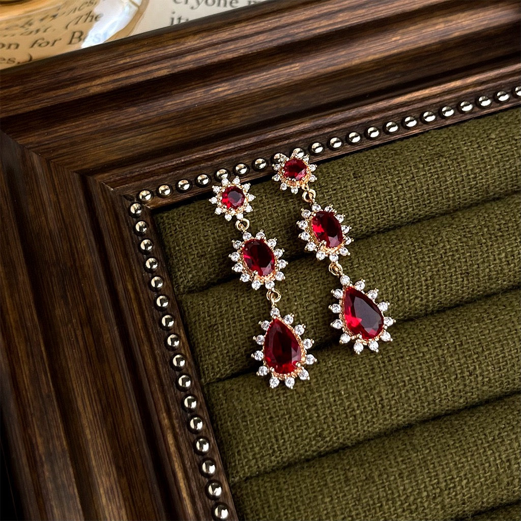 Style 3 long red drop earrings with clear-stone borders shown as a pair