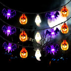 Purple bat, orange pumpkin and white ghost string lights in an illustrative display