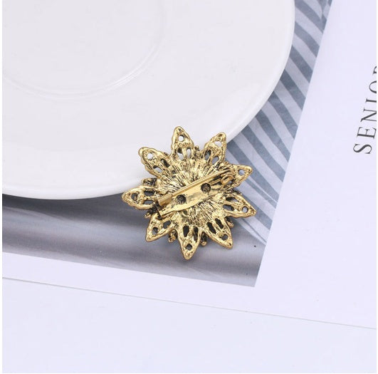 Rear of the floral brooch showing its horizontal bar-pin fastening