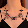 Black spider and web necklace with red accents, shown worn