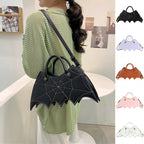 Black bat-wing-shaped bag worn over a green striped top, beside small images of five colour options.