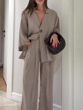 Taupe one-button top and wide-leg trousers worn by a model