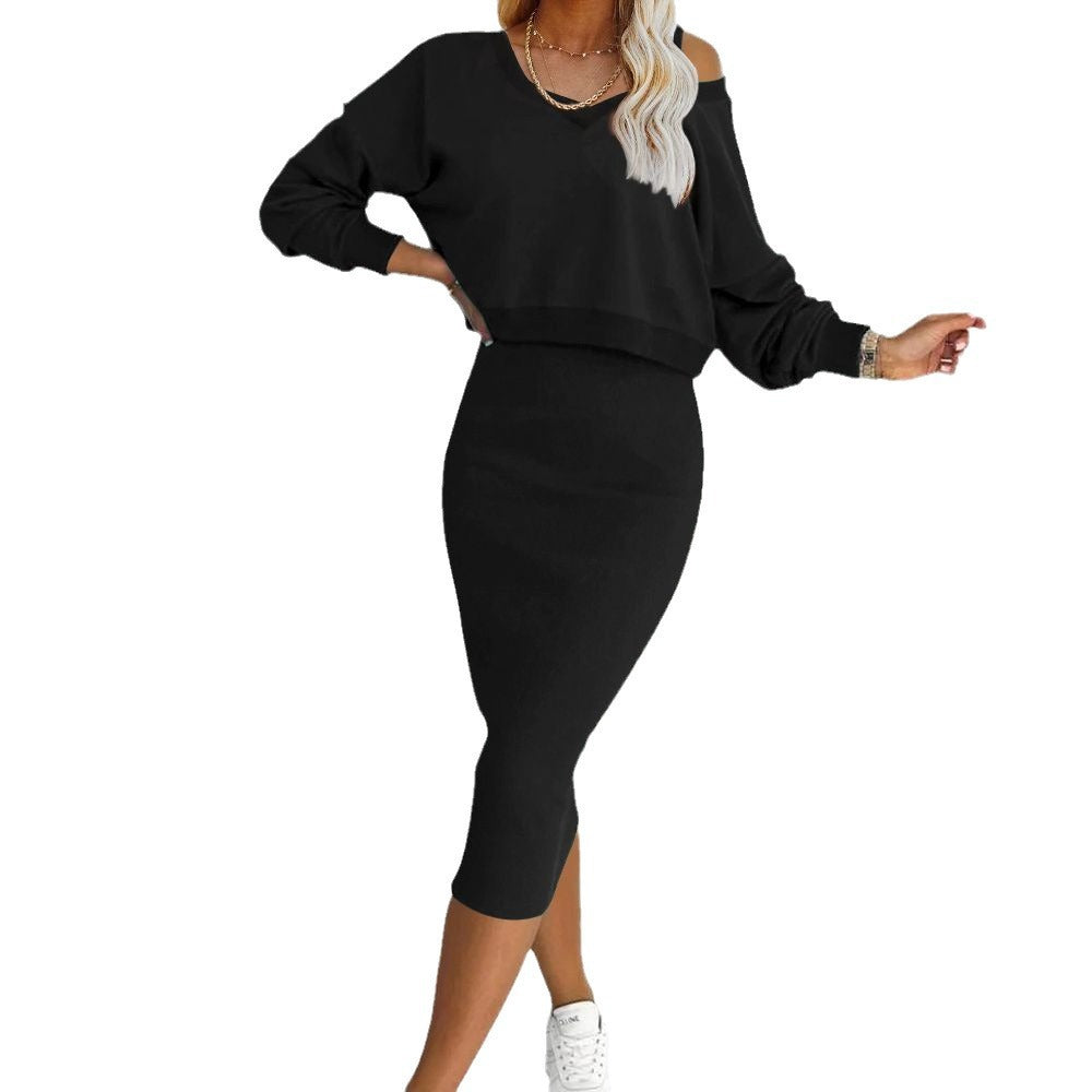 Black two-piece outfit with a long-sleeve top and matching sleeveless midi dress, shown worn.
