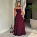 Red lace-up maxi dress with thin straps and a raised floral pattern, shown worn from the front.