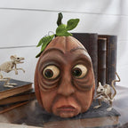 Expression A pumpkin ornament shown in a styled Halloween display.