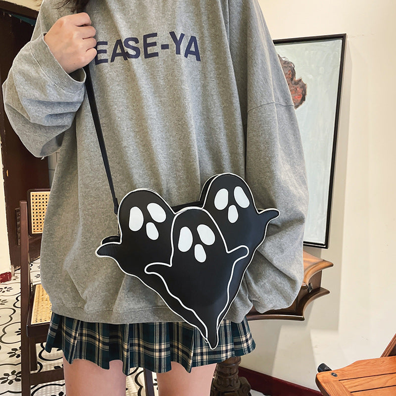 Front view of the black Ghost Crossbody Bag worn across the body.