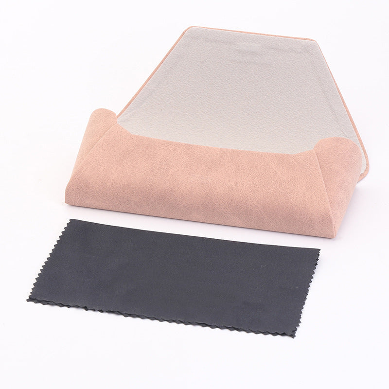 Open pink folding glasses case with a separate black cleaning cloth; sunglasses are not pictured