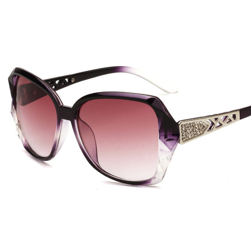 One pair of oversized purple-gradient sunglasses with decorative cutout temples on white
