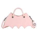 Pink bat-wing-shaped crossbody bag with spider-web stitching, handles and strap on white.