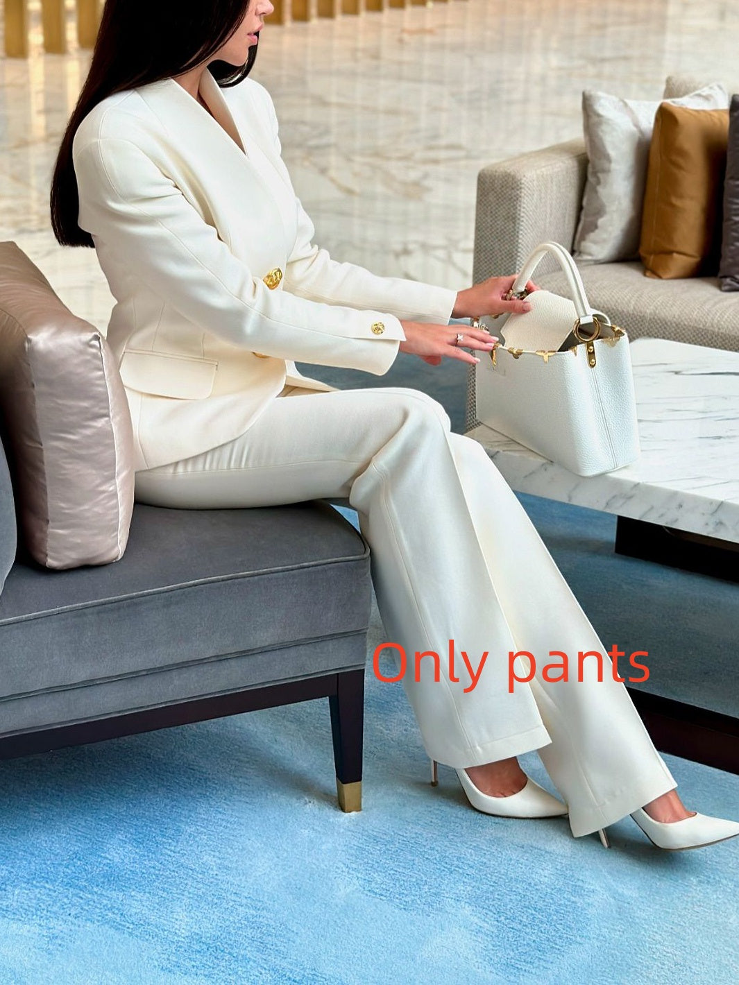 Trouser-only option: seated model wearing ivory flared trousers; original photograph is labelled Only pants
