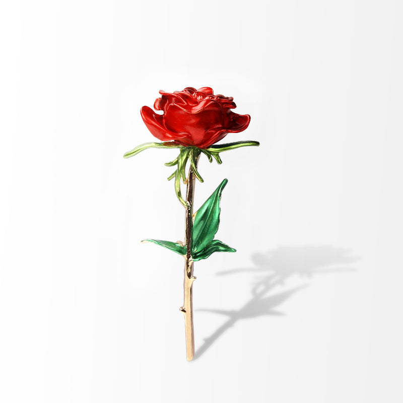 Red rose brooch with green leaves and gold-tone stem