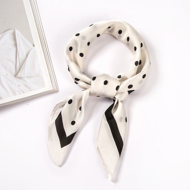 Beige scarf with black polka dots and a black border, shown knotted