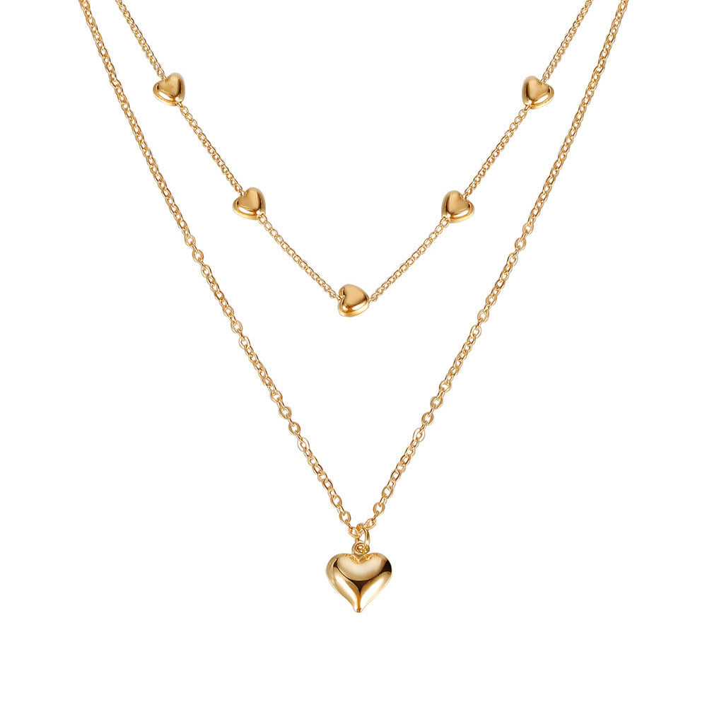 Gold-tone double-layer necklace with small heart charms and a larger heart pendant